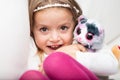 Cute laughing little girl with her fluffy toy Royalty Free Stock Photo