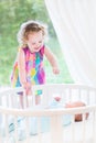 Cute laughing toddler girl with her newborn brother