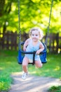 Cute laughing toddler girl swinging ride on playground Royalty Free Stock Photo