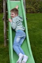 Cute lboy plays on a slide Royalty Free Stock Photo