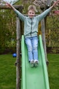 Cute lboy plays on a slide Royalty Free Stock Photo