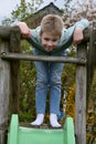 Cute boy plays on a slide Royalty Free Stock Photo