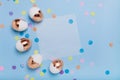 Cute light blue background with gilded eggs and confetti