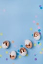 Cute light blue background with gilded eggs and confetti