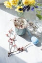 Cute light spring Easter still life. Branches with flowering fruit trees and a painted egg Royalty Free Stock Photo