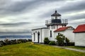 Cute lighthouse stands watch under a cloudy sky