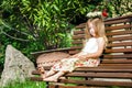 Cute litle barefoot girl sitting on the bench Royalty Free Stock Photo