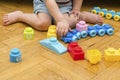 Cute little adorable caucasian boy playing with multi-colored constructor at home. Babys hands building tower of plastic Royalty Free Stock Photo