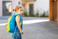 Cute little adorable toddler girl on her first day going to playschool. Healthy upset sad baby walking to nursery school. Fear of Royalty Free Stock Photo