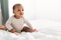 Cute little African American baby sitting in bed Royalty Free Stock Photo