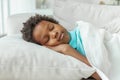 Cute little African American boy child sleeping in bed Royalty Free Stock Photo