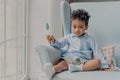 Cute little african american boy with lollipop indoors Royalty Free Stock Photo