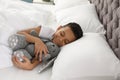 Cute little African-American boy with toy rabbit sleeping Royalty Free Stock Photo