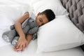 Cute little African-American boy with toy rabbit sleeping Royalty Free Stock Photo
