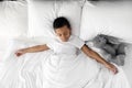 Cute little African-American boy with toy rabbit sleeping in bed Royalty Free Stock Photo