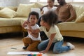 Small biracial kids sit on floor drawing together Royalty Free Stock Photo