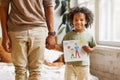 Cute little african american boy son holding hand drawing with happy family for dad on Fathers day Royalty Free Stock Photo