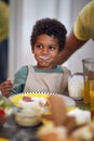 Cute little african boy smiling at table, with milk moustache Royalty Free Stock Photo