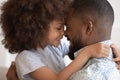 Cute little african daughter embrace touch noses with happy dad Royalty Free Stock Photo