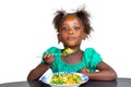 Cute little african kid eating a mixed vegetable dish Royalty Free Stock Photo