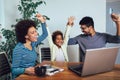Little Afro-American girl and her beautiful young parents using a laptop and doing shopping online Royalty Free Stock Photo