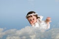 Cute little angel in clouds on blue sky background