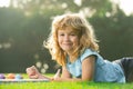 Cute little artist boy. Child boy enjoying art and craft drawing in backyard or spring park. Children drawing draw with