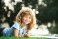 Cute little artist boy. Portrait of smiling happy kid enjoying art and craft drawing in backyard or spring park Royalty Free Stock Photo