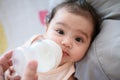 Cute little asian baby girl was drinking from the bottle fed by my mother Royalty Free Stock Photo