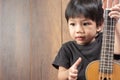 Cute Little Asian Boy with ukulele. Royalty Free Stock Photo