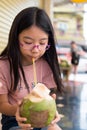 Cute girl drinking coconut water