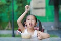 Cute little Asian child girl eating Instant noodles on the table