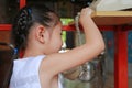 Cute little asian child girl talking on the retro telephone Royalty Free Stock Photo