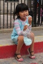 cute little asian chinese girl eating cotton candy Royalty Free Stock Photo