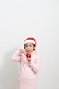 Girl holding a red christmas ball in sweater and santa hat Royalty Free Stock Photo