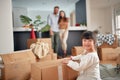 Cute little asian girl  looking at camera, smiling, with her parents in the background Royalty Free Stock Photo