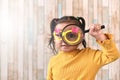 Cute little asian girl looking through a magnifying glass. Royalty Free Stock Photo