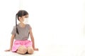 Cute little Asian girl with pigtails Wear a white mask sitting on a white floor. Royalty Free Stock Photo