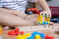 Cute little Asian girl playing with colorful toy blocks. Educational and creative toys and games for young children