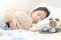 Cute little asian girl sleep and hug teddy bear on bed Royalty Free Stock Photo