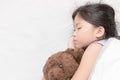 Cute little asian girl sleep and hug teddy bear Royalty Free Stock Photo