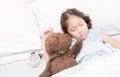 Cute little asian girl sleep and hug teddy bear Royalty Free Stock Photo