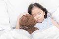 Cute little asian girl sleep and hug teddy bear Royalty Free Stock Photo