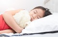 Cute little asian girl sleep and hug teddy bear on bed Royalty Free Stock Photo