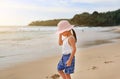 Cute little asian girl wear straw hat walking on the beach Royalty Free Stock Photo