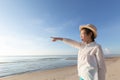 Cute little asian girl wear straw hat walking on the beach with Royalty Free Stock Photo