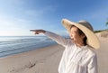 Cute little asian girl wear straw hat walking on the beach with Royalty Free Stock Photo