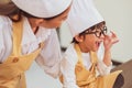 Cute little Asian happy boy interested in cooking with mother funny in home kitchen. People lifestyles and Family. Homemade food Royalty Free Stock Photo