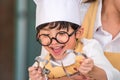 Cute little Asian happy boy interested in cooking with mother funny in home kitchen. People lifestyles and Family. Homemade food Royalty Free Stock Photo