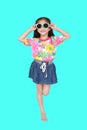 Cute little Asian kid girl wearing a flowers summer dress and sunglasses isolated on cyan background. Summer and fashion concept Royalty Free Stock Photo